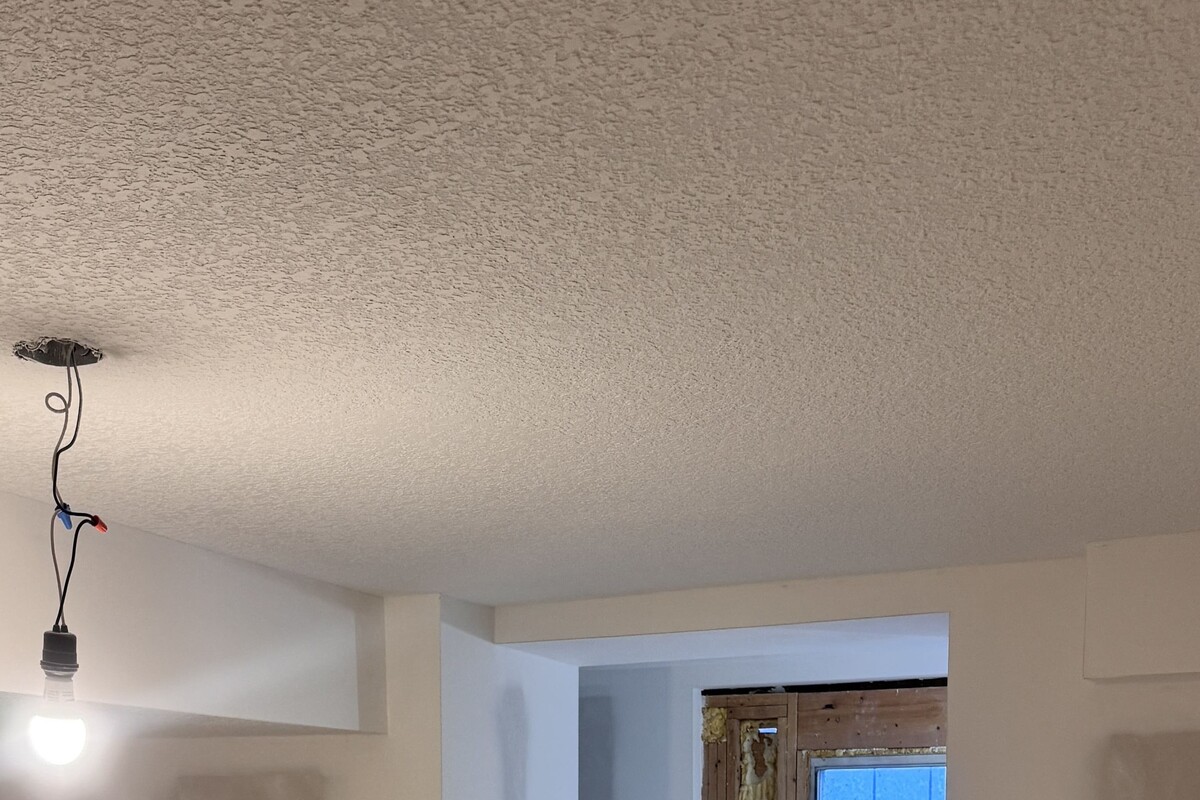 Basement drywall and ceiling texture installation by DryBuild Group in Calgary, Alberta.