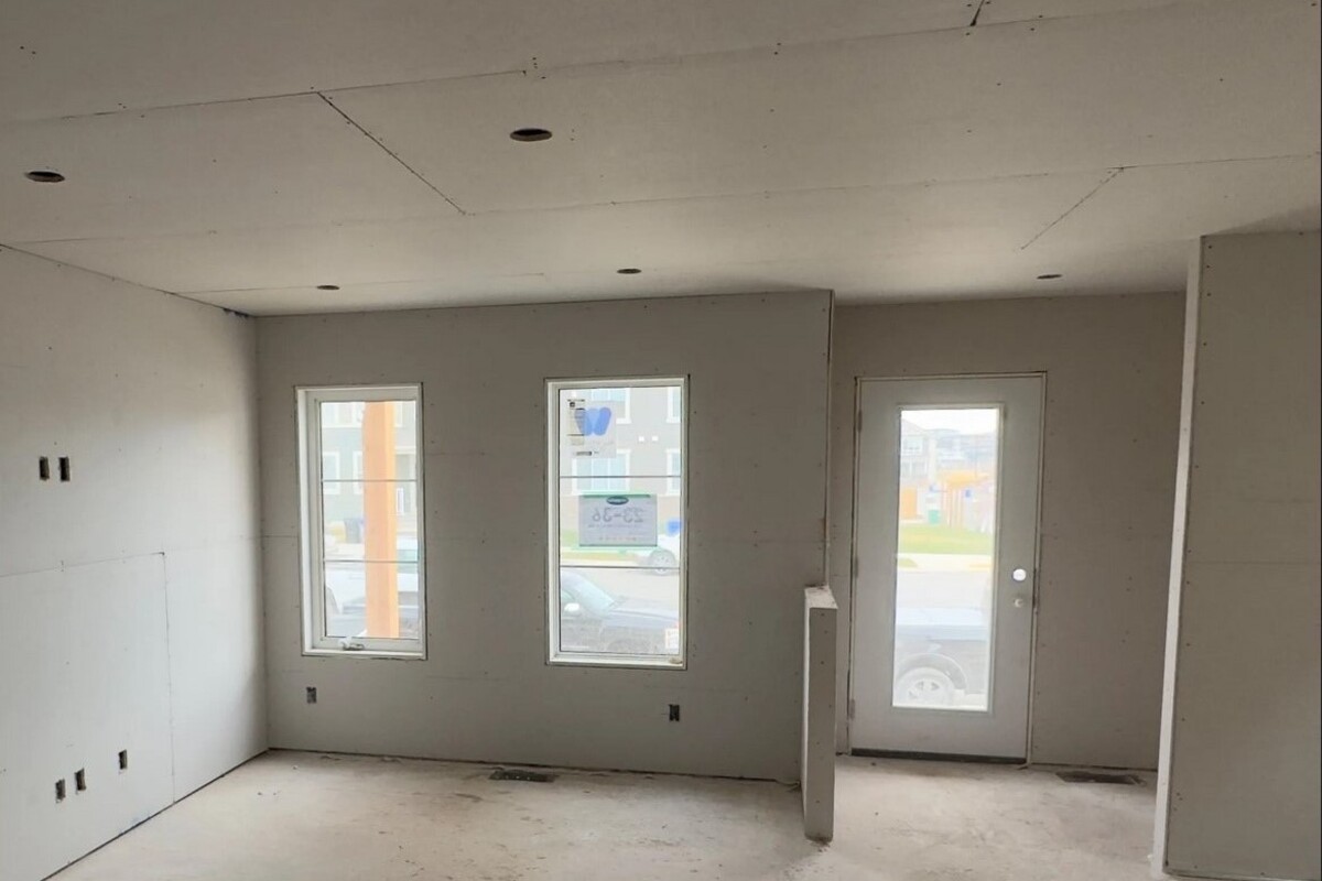 Drywall installation service in Alberta — professionals installing sheetrock panels